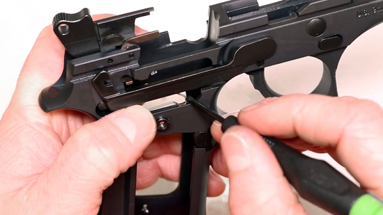 Gunsmith Installing New Springs in a Disassembled Beretta 92FS