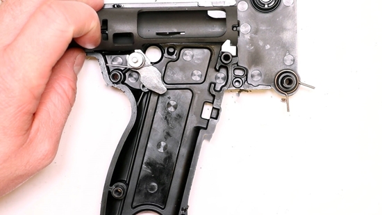 A Gunsmith Disassembling the Left Side Grip Frame of a SUB 2000
