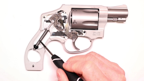 A Gunsmith Removing the Hammer Spring on a Smith and Wesson J-Frame Revolver