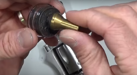 A Gunsmith Saturating the Brass Lapping Tool with the Silicon Carbide Lapping Compound
