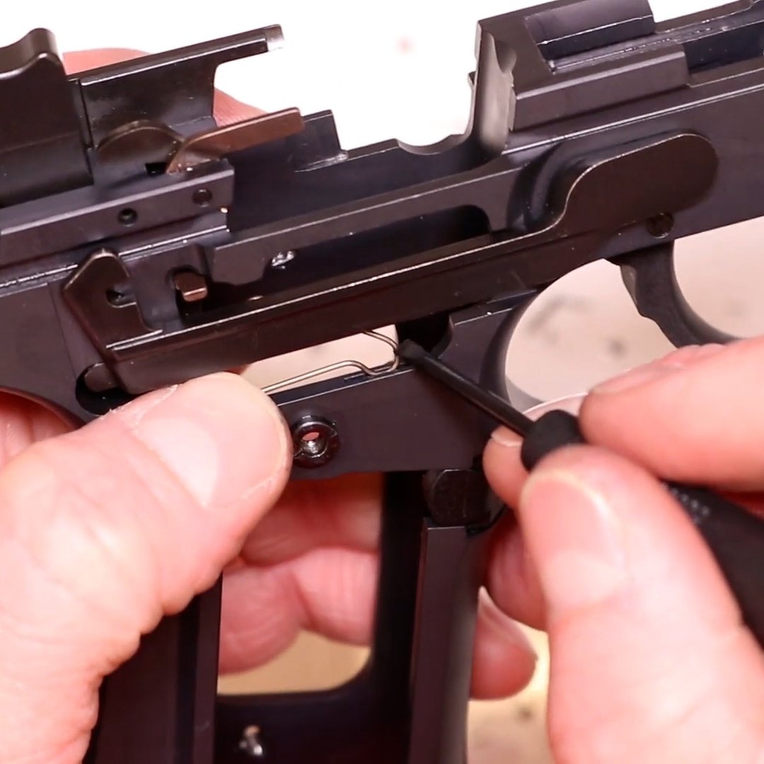 Gunsmith Installing New Springs in a Disassembled Beretta 92FS